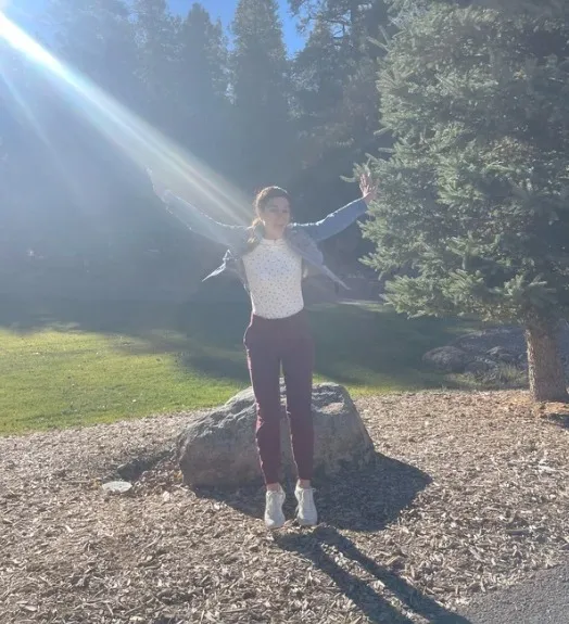 Tracy jumping for joy in the sunlight